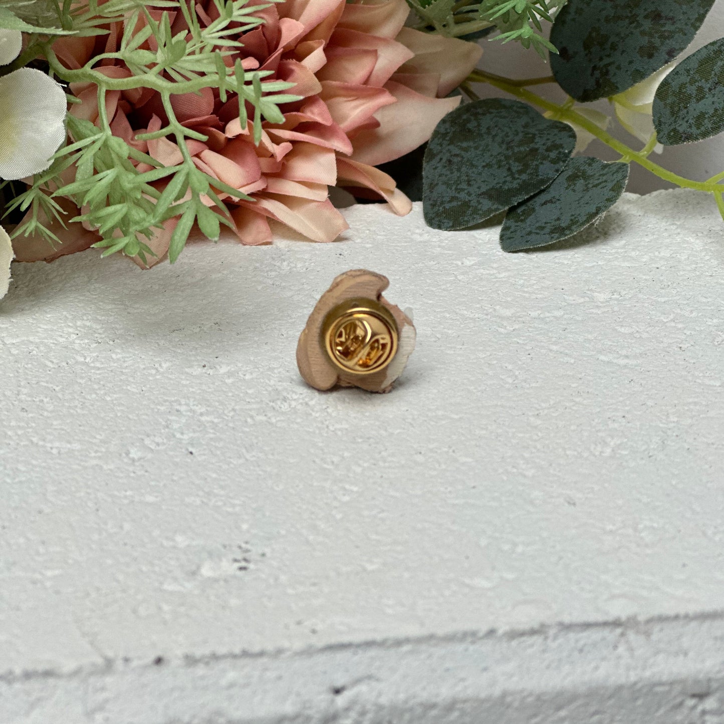 Custom dog lapel pin on white background.