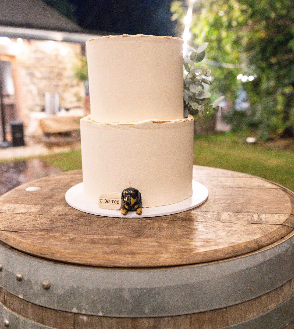 Custom dachshund dog peeking topper in a real wedding cake.