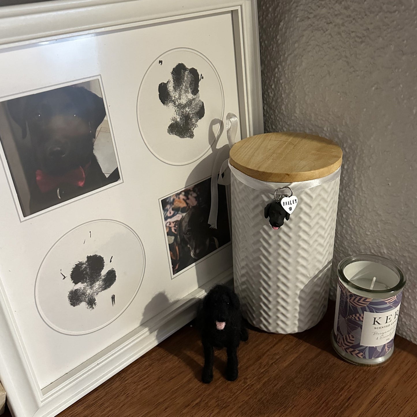 Custom dog urn charm hanging on urn with pet's ashes.