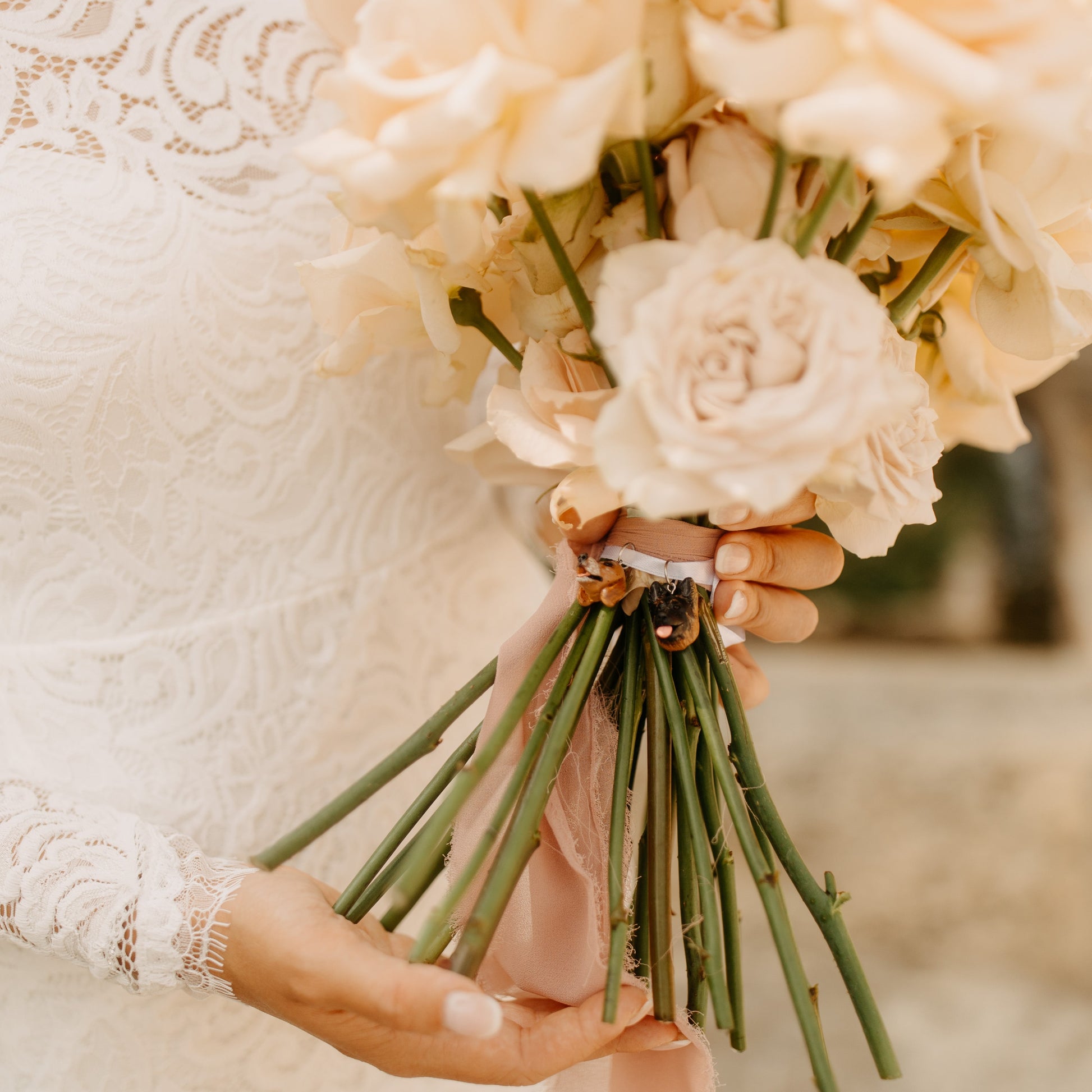 Custom pet bridal bouquet charm photo from a wedding day, featuring 2 dog faces.