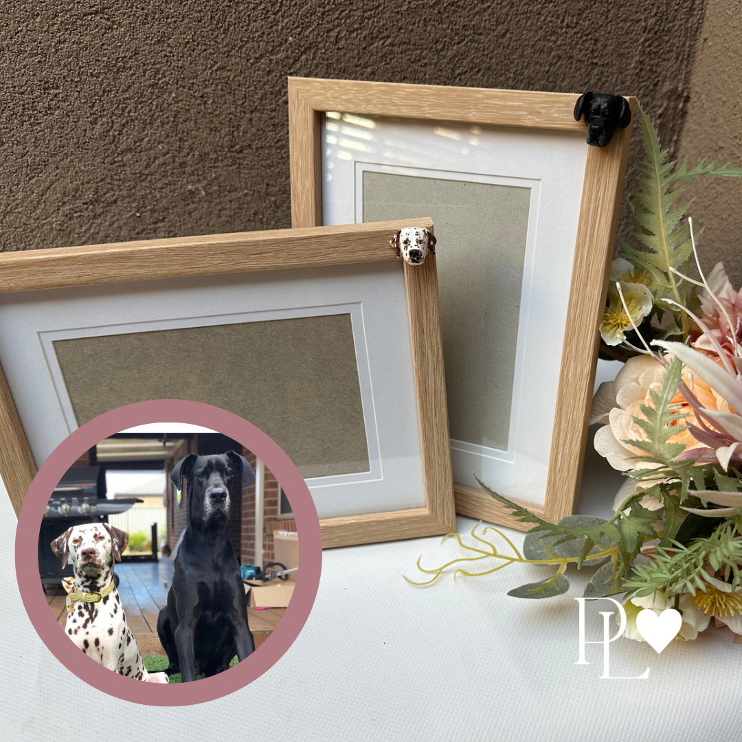 2 custom handmade pet photo frames, both in oak colour with 2 different dog faces.