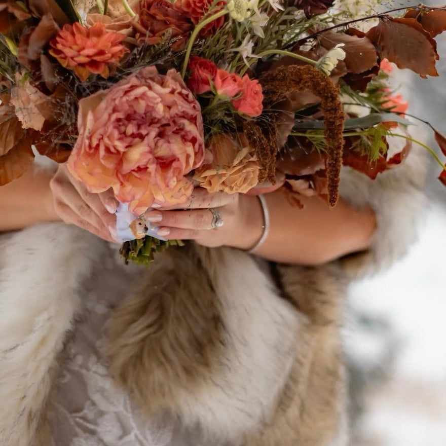 Custom pet bridal bouquet charm photo from a wedding day, featuring a golden retriever face.