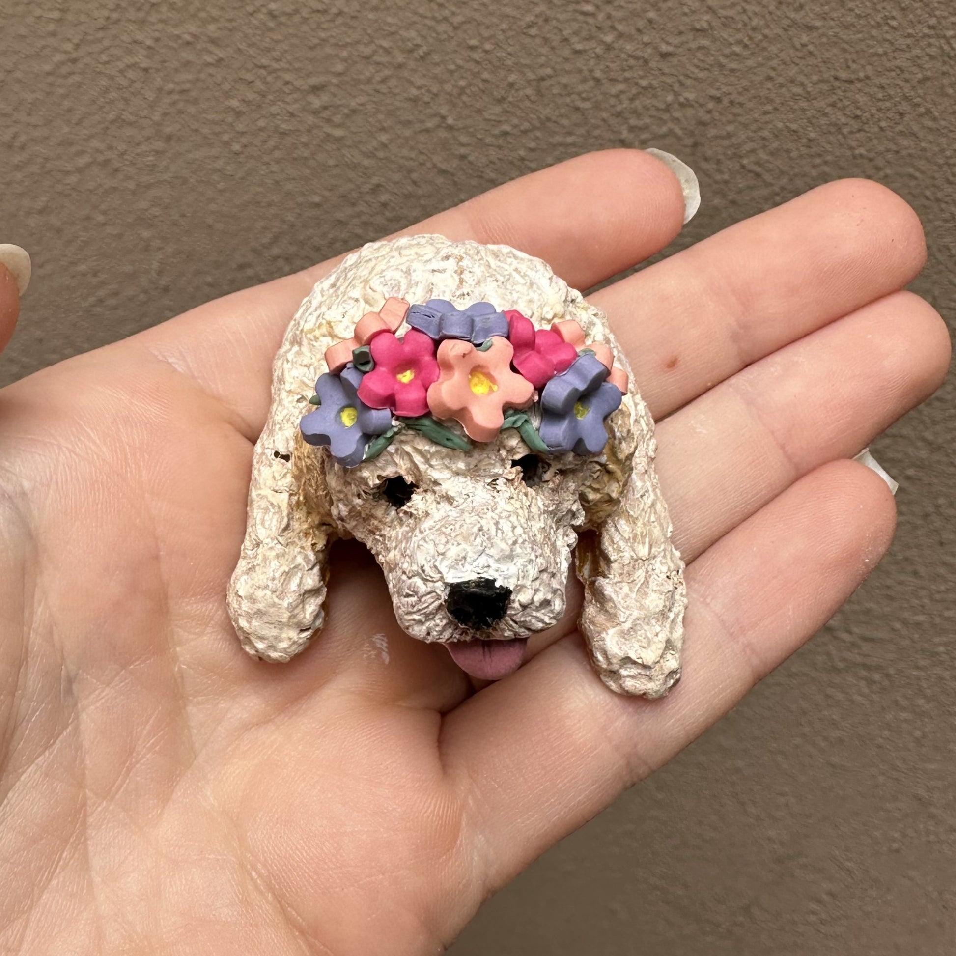 Handmade peeking cavoodle cake topper wearing a flower crown.