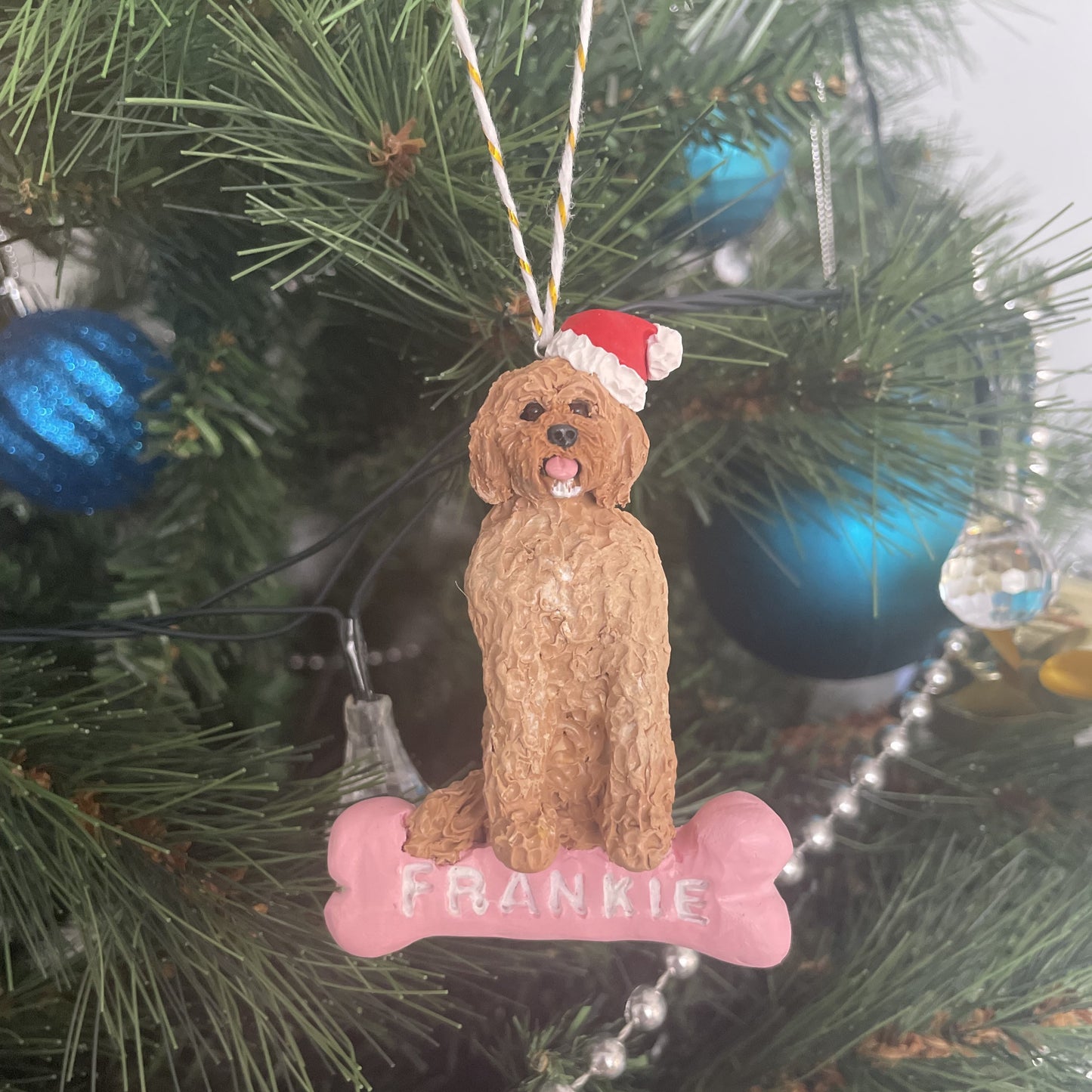 Custom dog sitting on a bone Christmas handing ornament