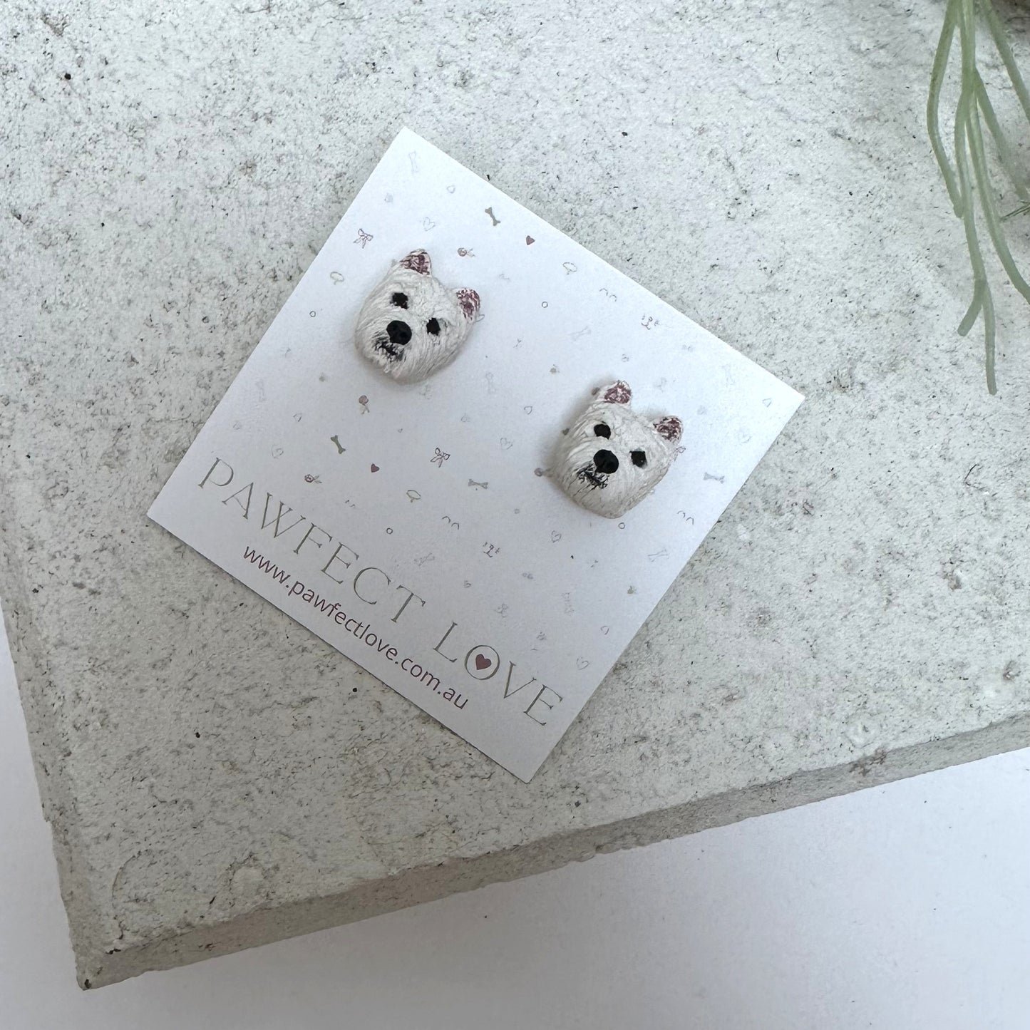 Westie earrings on a branded card with 'PAWfect Love' on a textured surface.