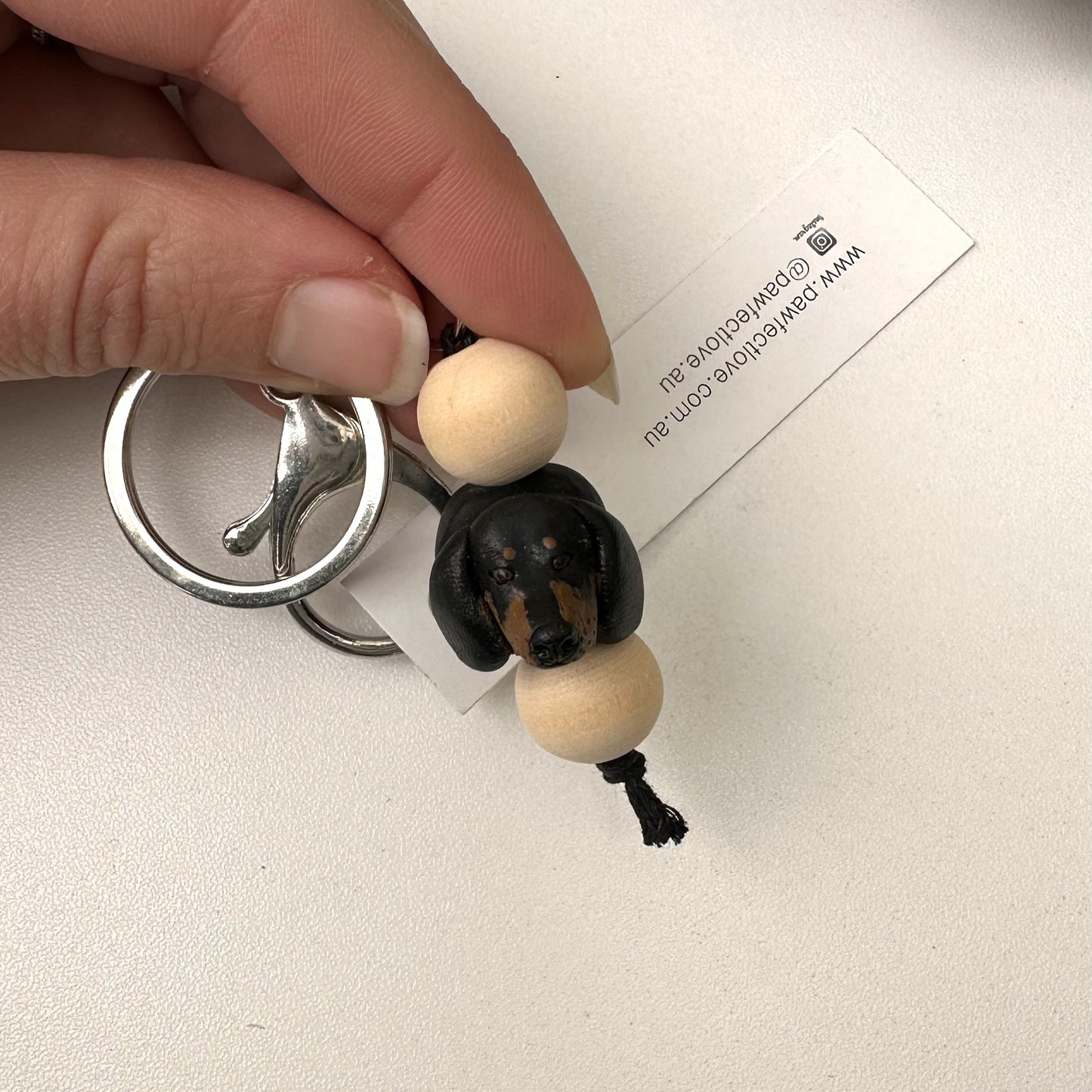 Keychain with a small dachshund dog handmade keyring on a white background