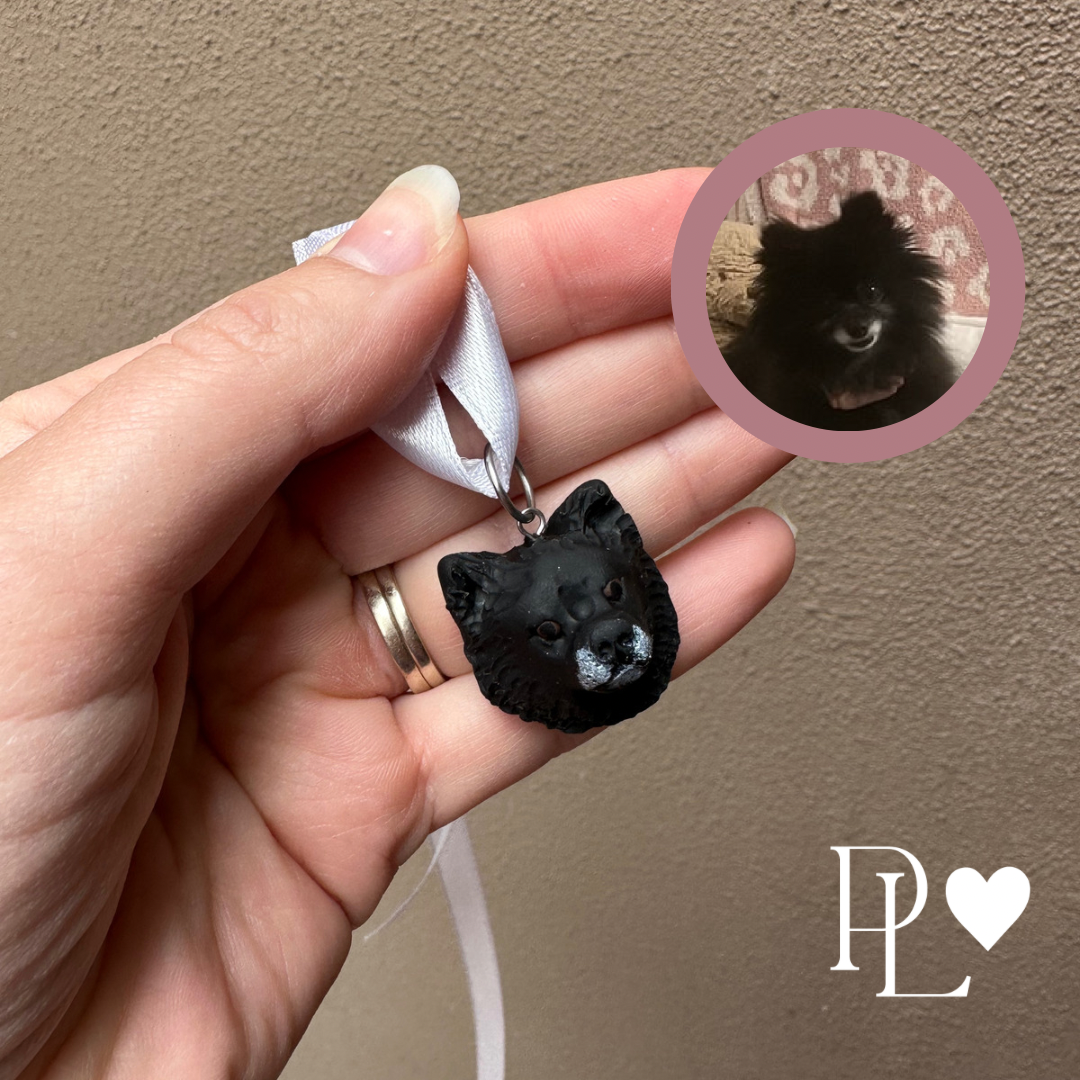 Small blach dog handmade charm on a ribbon.