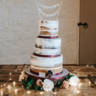 Custom dachshund dog peeking topper in a real wedding cake.