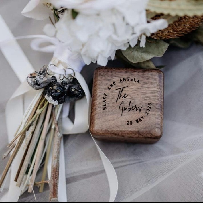 Custom pet bridal bouquet charm photo from a wedding day, featuring 3 cat faces..