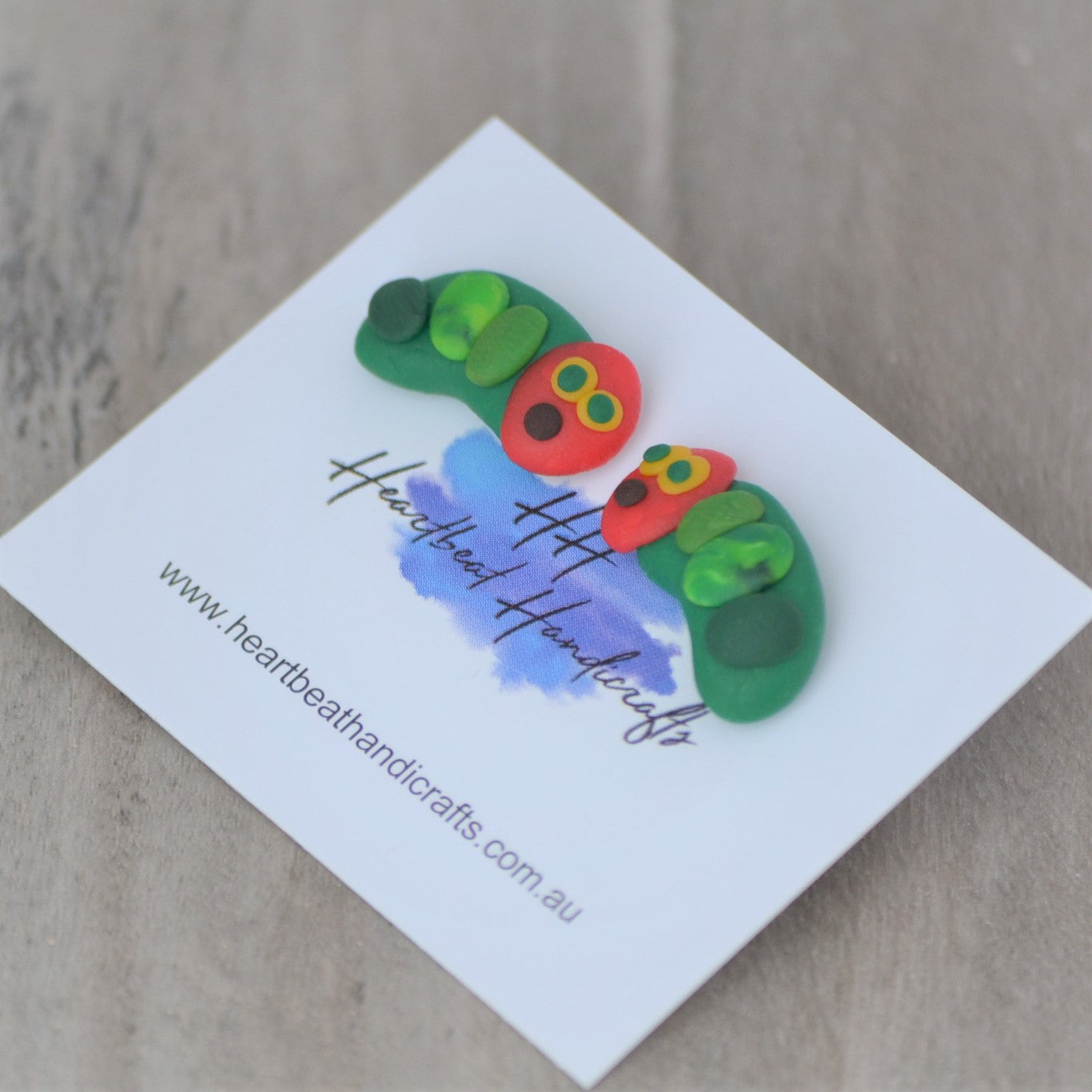 Close up details of caterpillars stud earrings shown