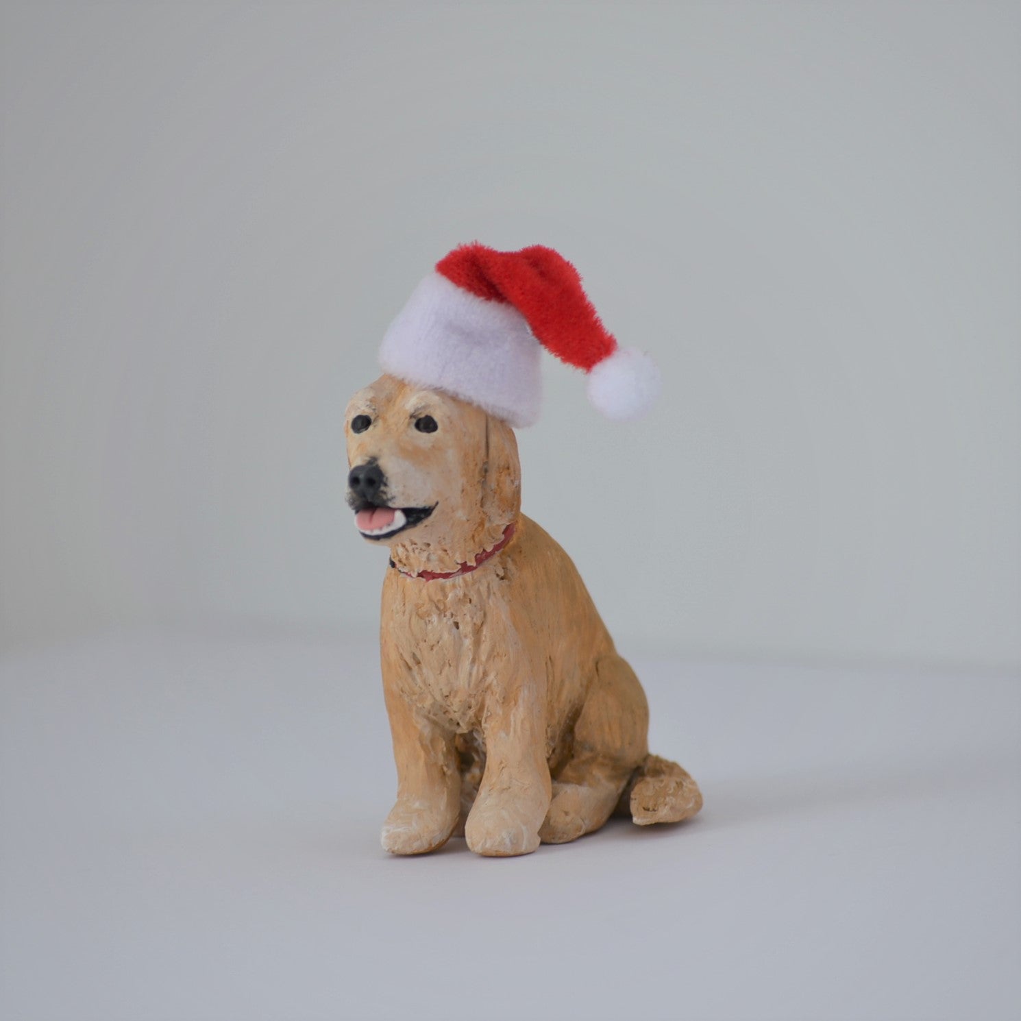 Handmade custom golden retriever dog figurine with santa hat