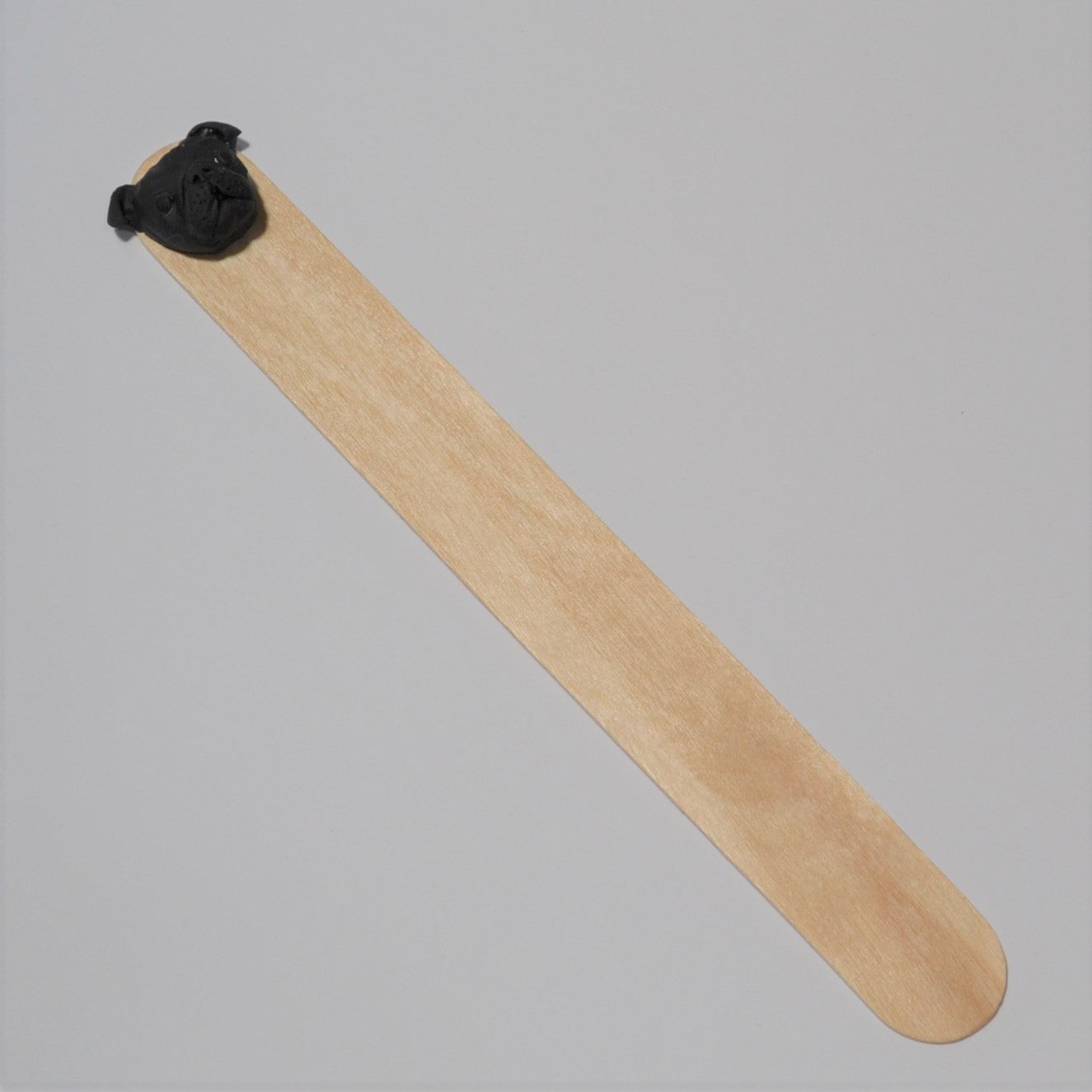 Handmade custom pet face bookmark showing a black pug's face.