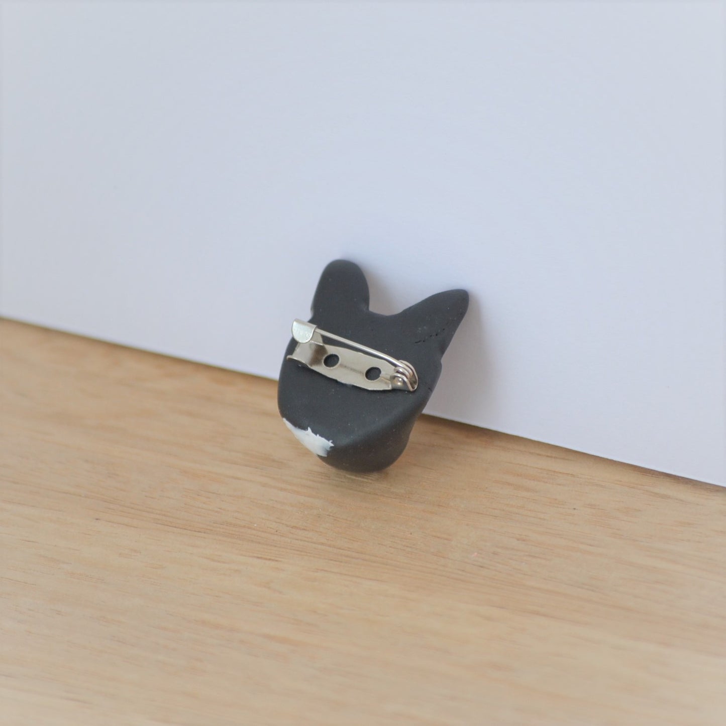 Back of handmade cat brooch, showing silver bar pin.