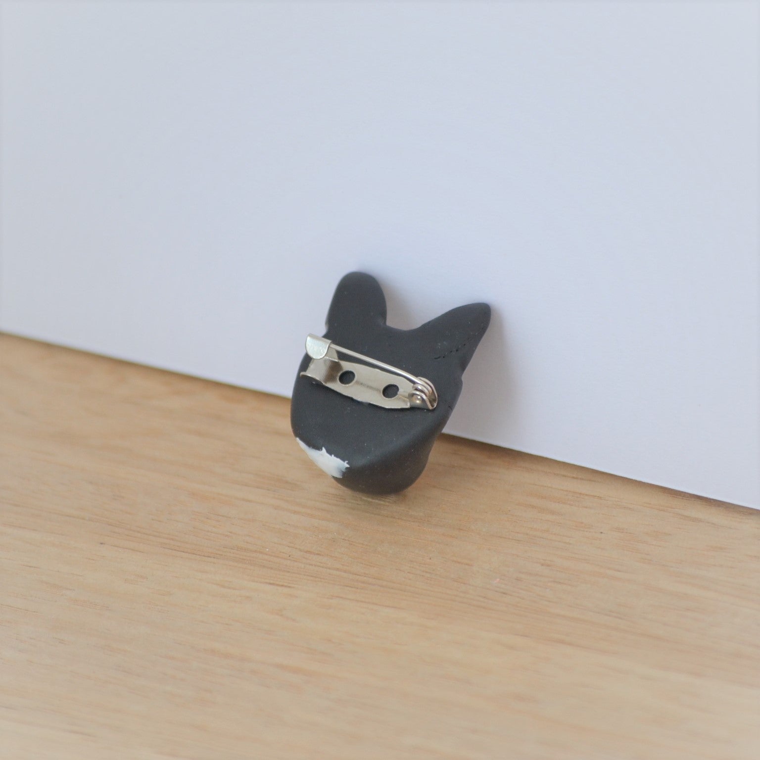 Back of handmade cat brooch, showing silver bar pin.