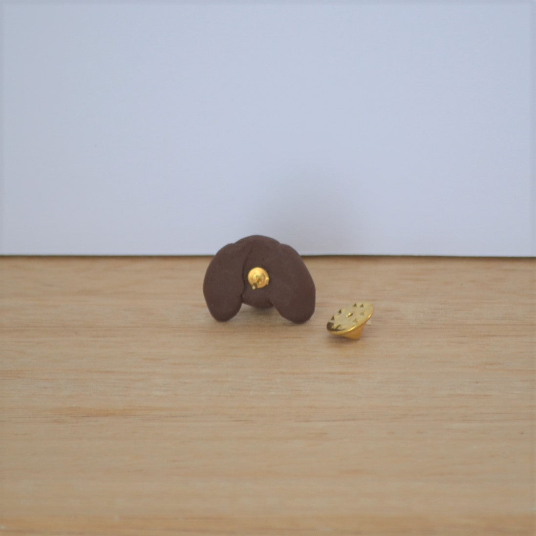 Back of handmade custom dog lapel pin, showing gold tie tack..