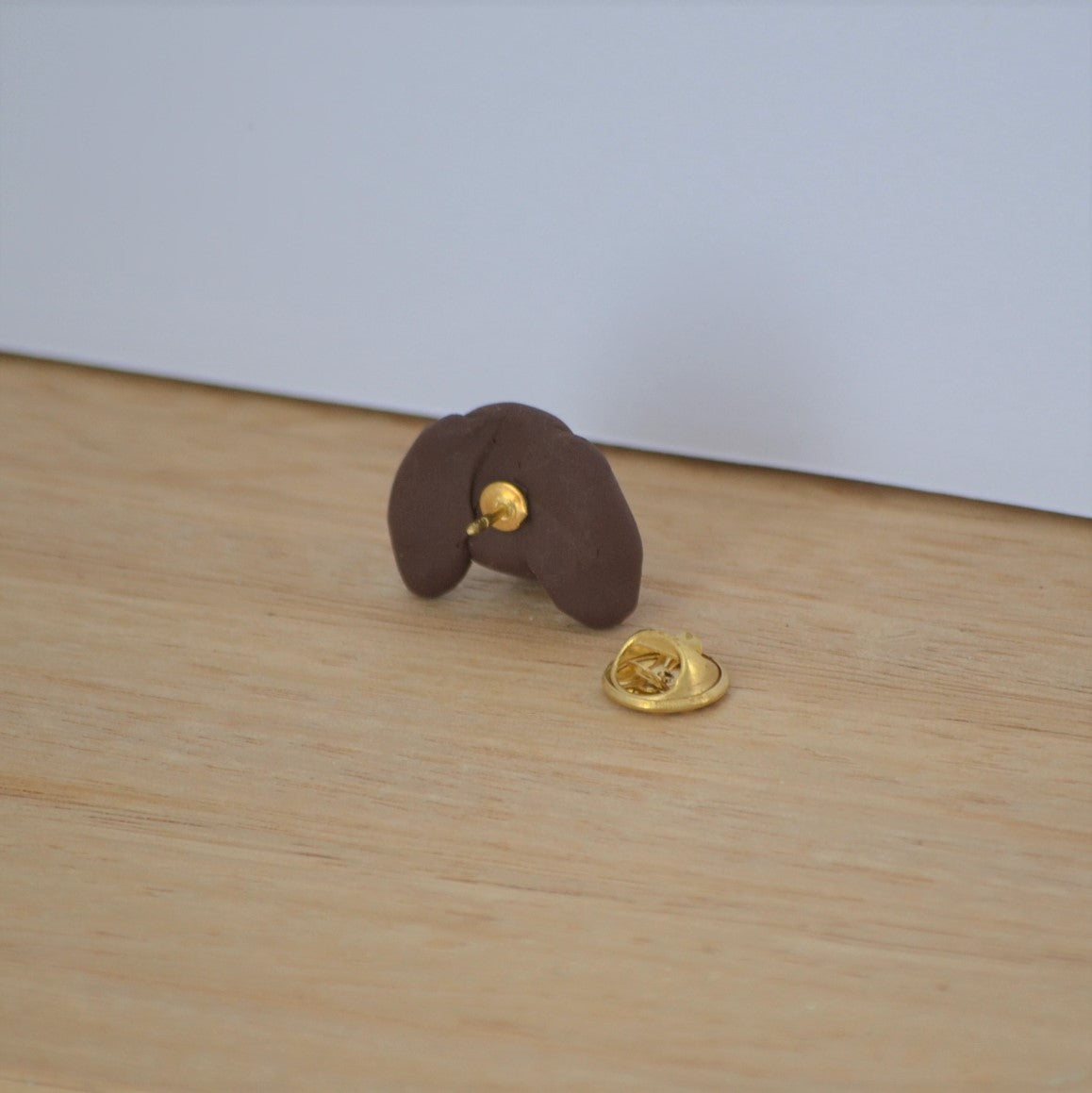 Back of handmade custom dog lapel pin.