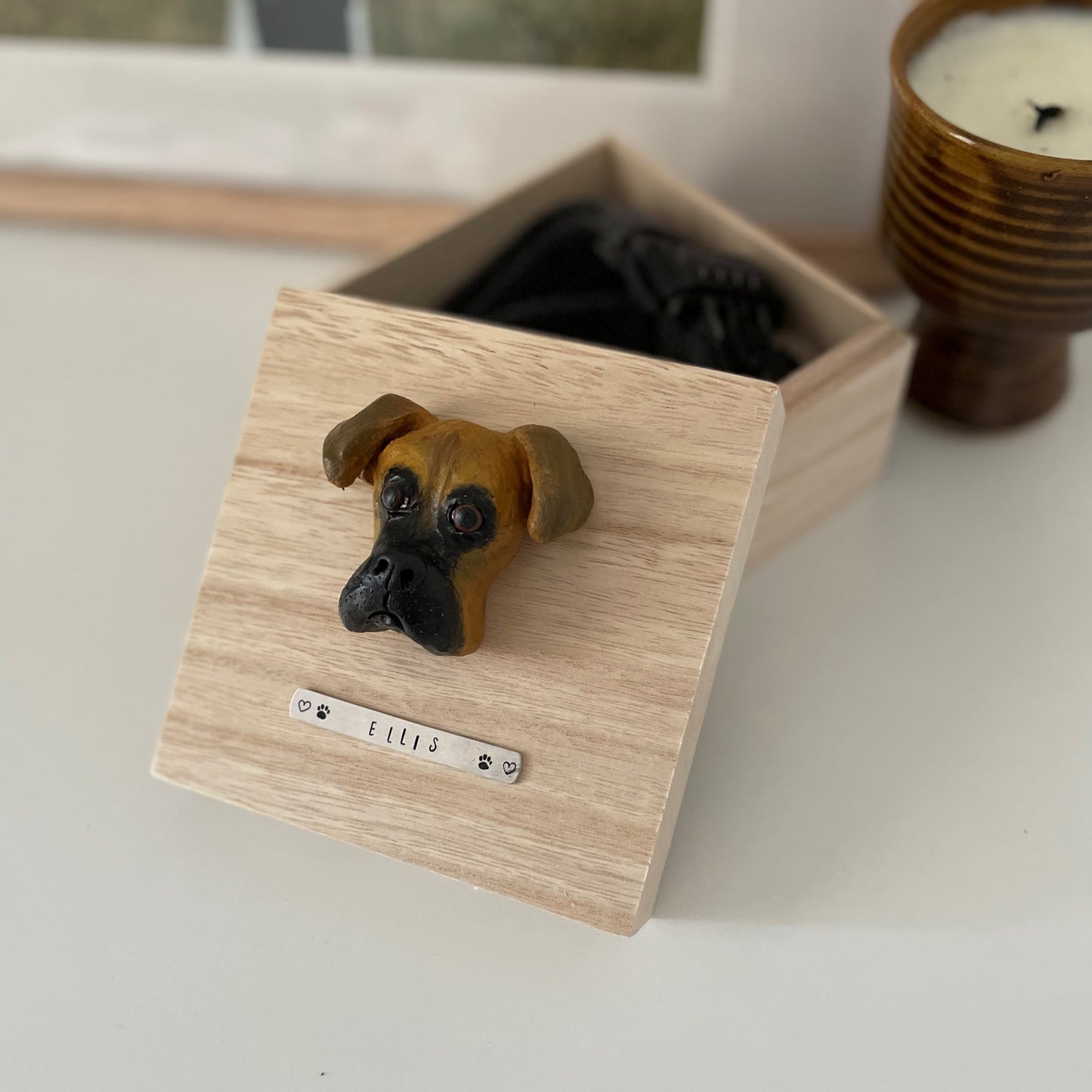 Custom timber pet memorial keepsake box with handscultped dog face on the lid, with a name plaque reading Ellis.