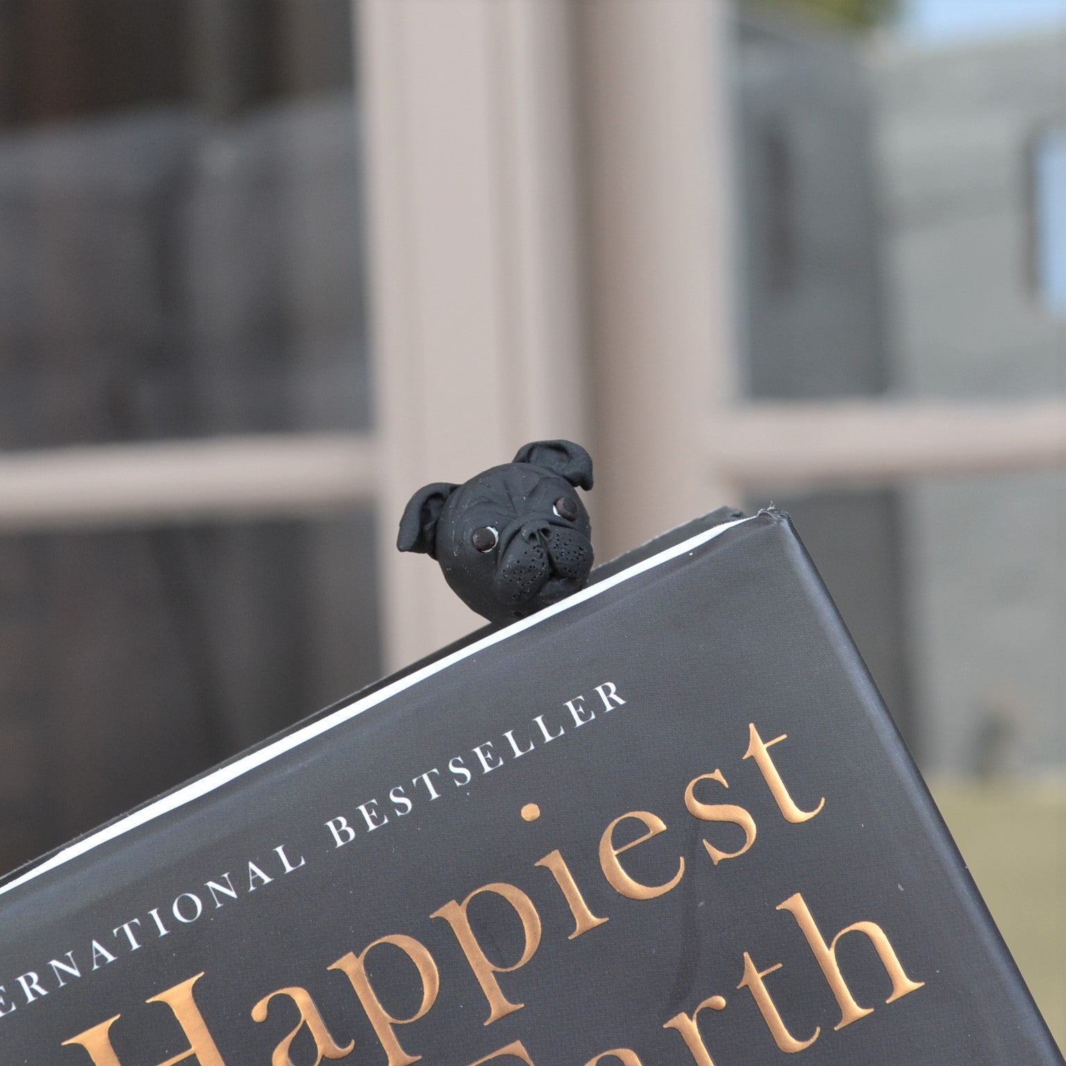 Handmade custom pet face page keeper showing a black pug's face.