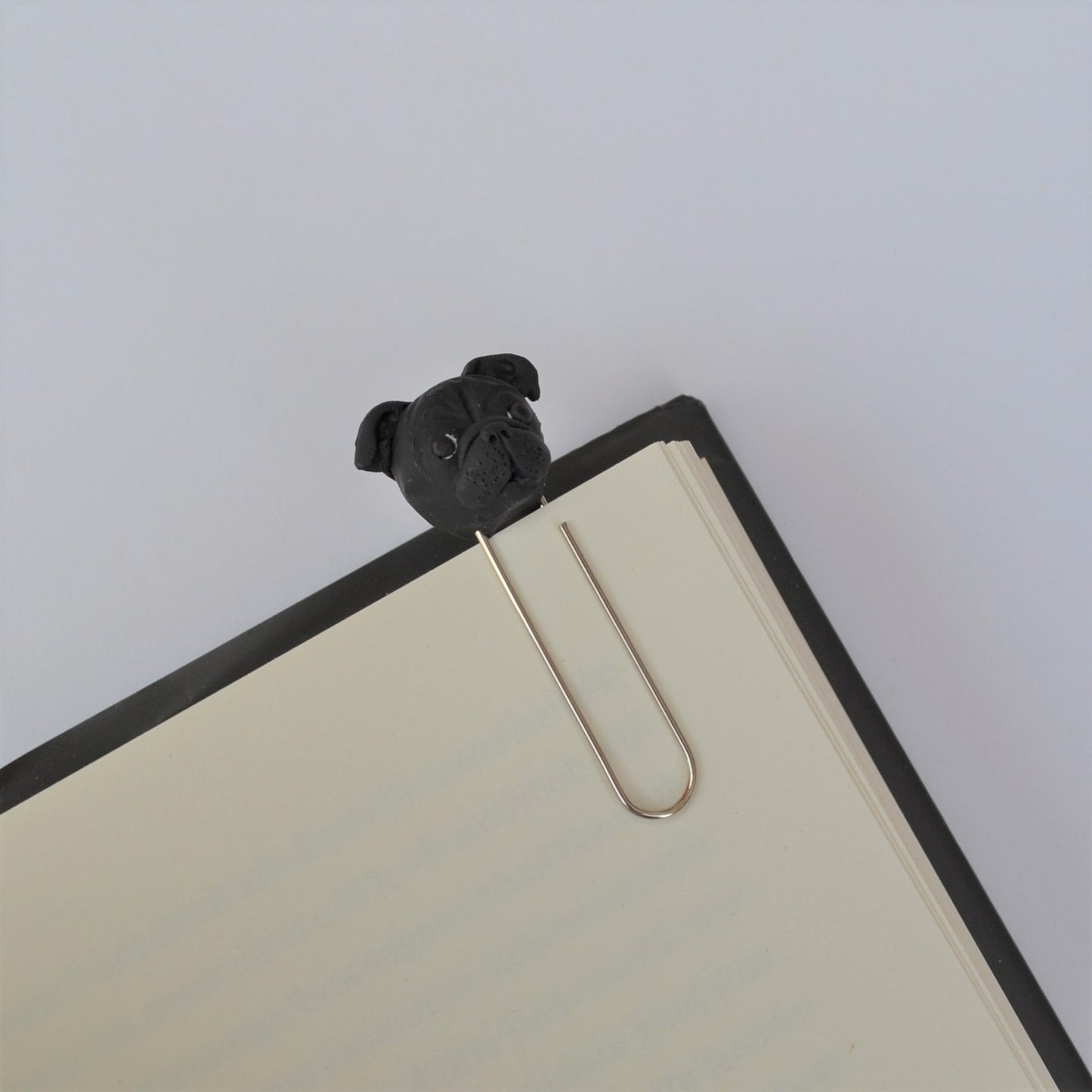 Handmade custom pet face page keeper showing a black pug's face.