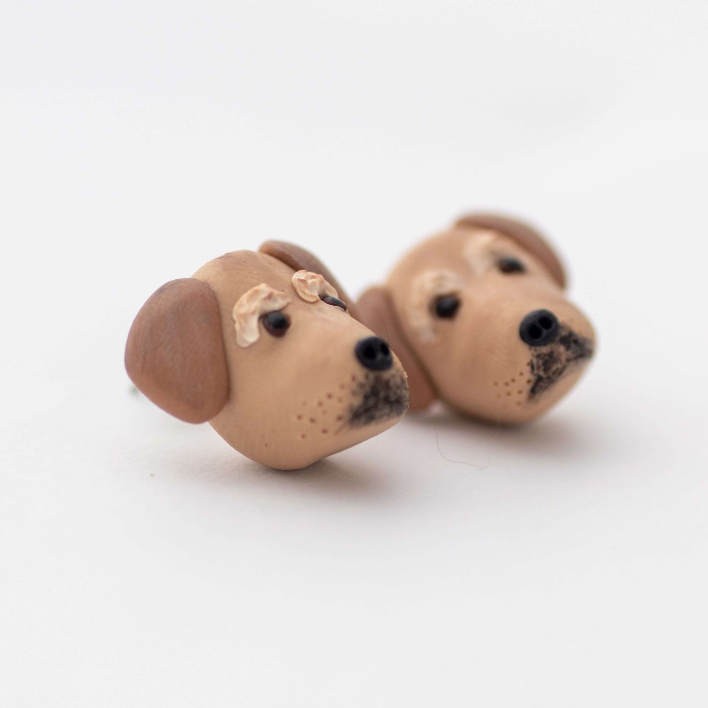 Handmade polymer clay golden retriever dog stud earrings on white background