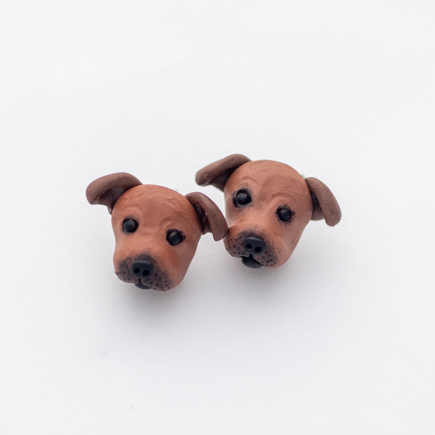 Handmade polymer clay Staffy stud earrings shown off card