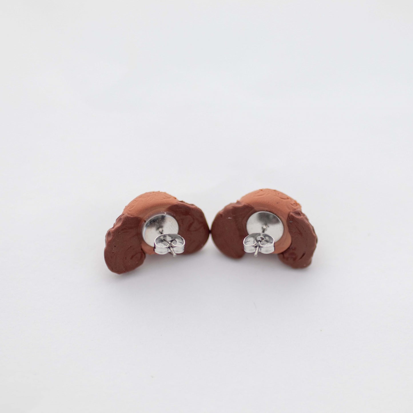 Handmade polymer clay Cavoodle stud earrings showing surgical steel backs