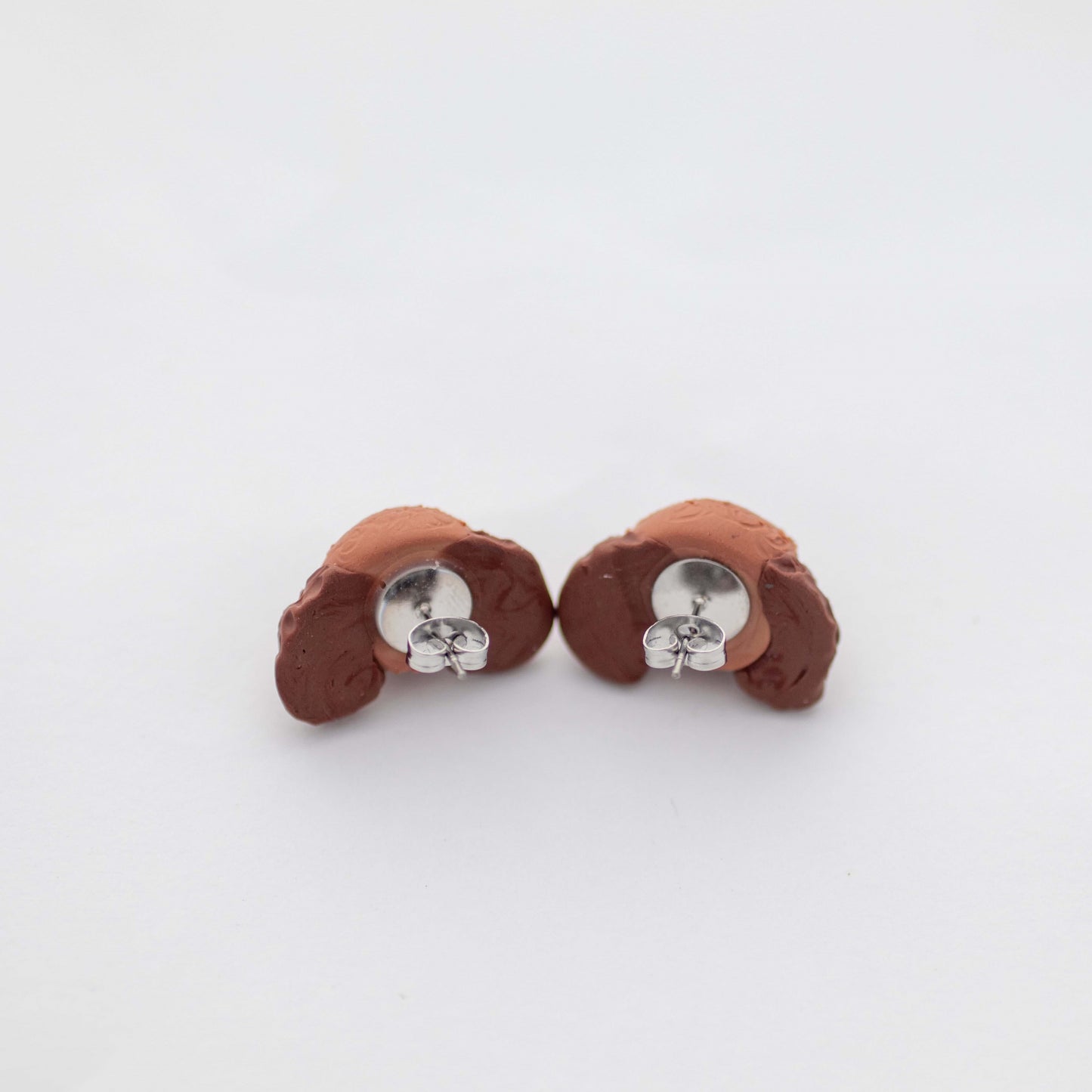 Handmade polymer clay Cavoodle stud earrings showing surgical steel backs
