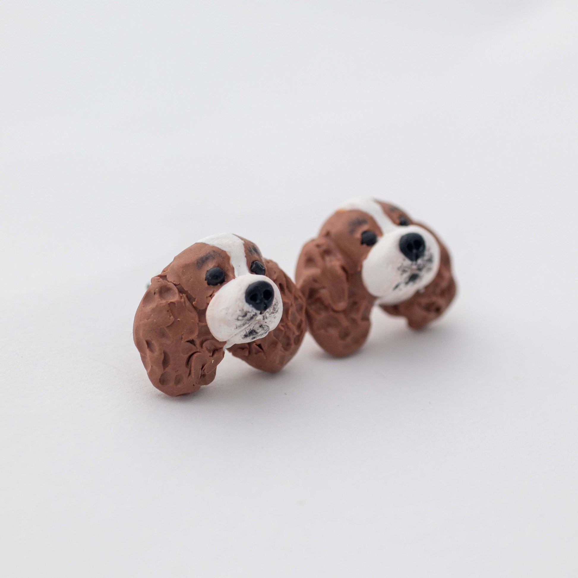 Handmade polymer clay cavalier king charles spaniel stud earrings shown on white background