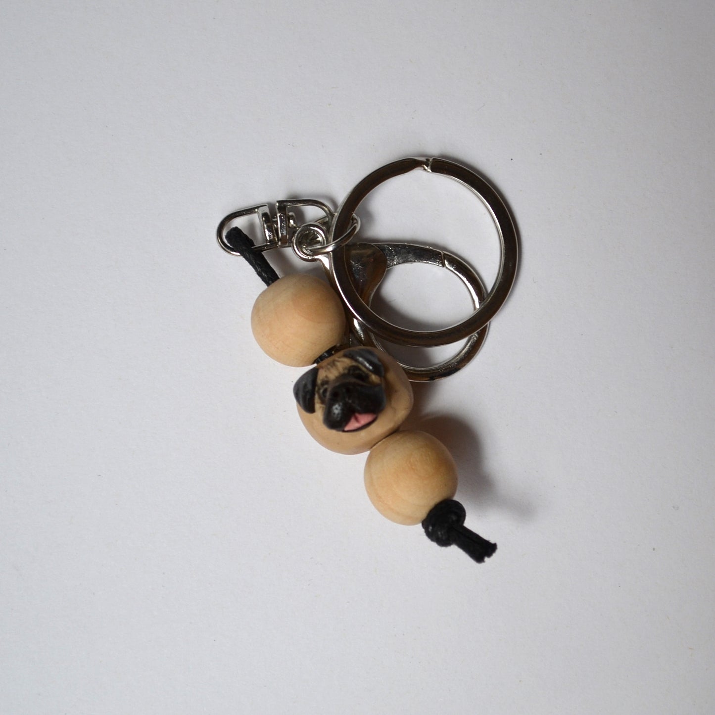 Handmade timber and polymer clay pug dog keychain on white background
