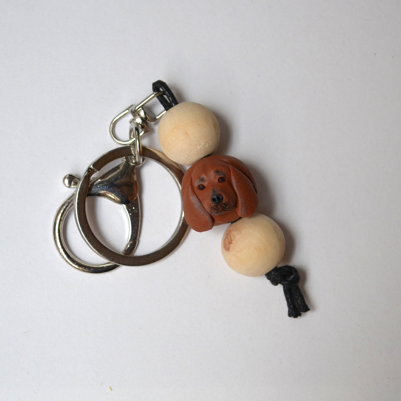 Handmade timber and polymer clay dachshund dog keychain on white background