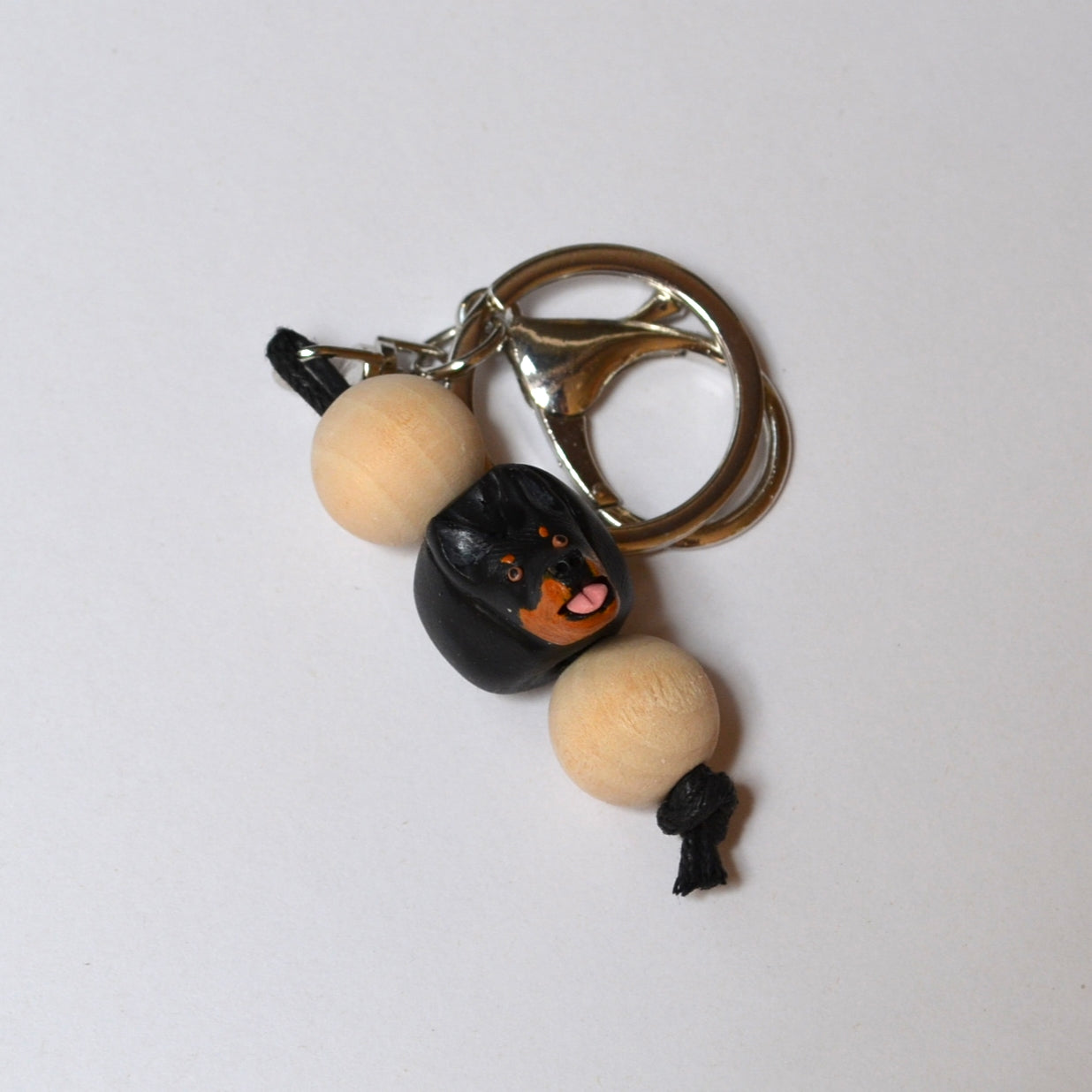 Polymer clay and timber handmade kelpie keyring on white background