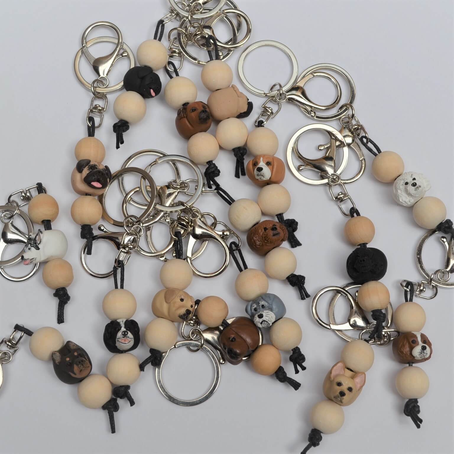 Photo of a group of handmade timber and polymer clay dog breed keychains
