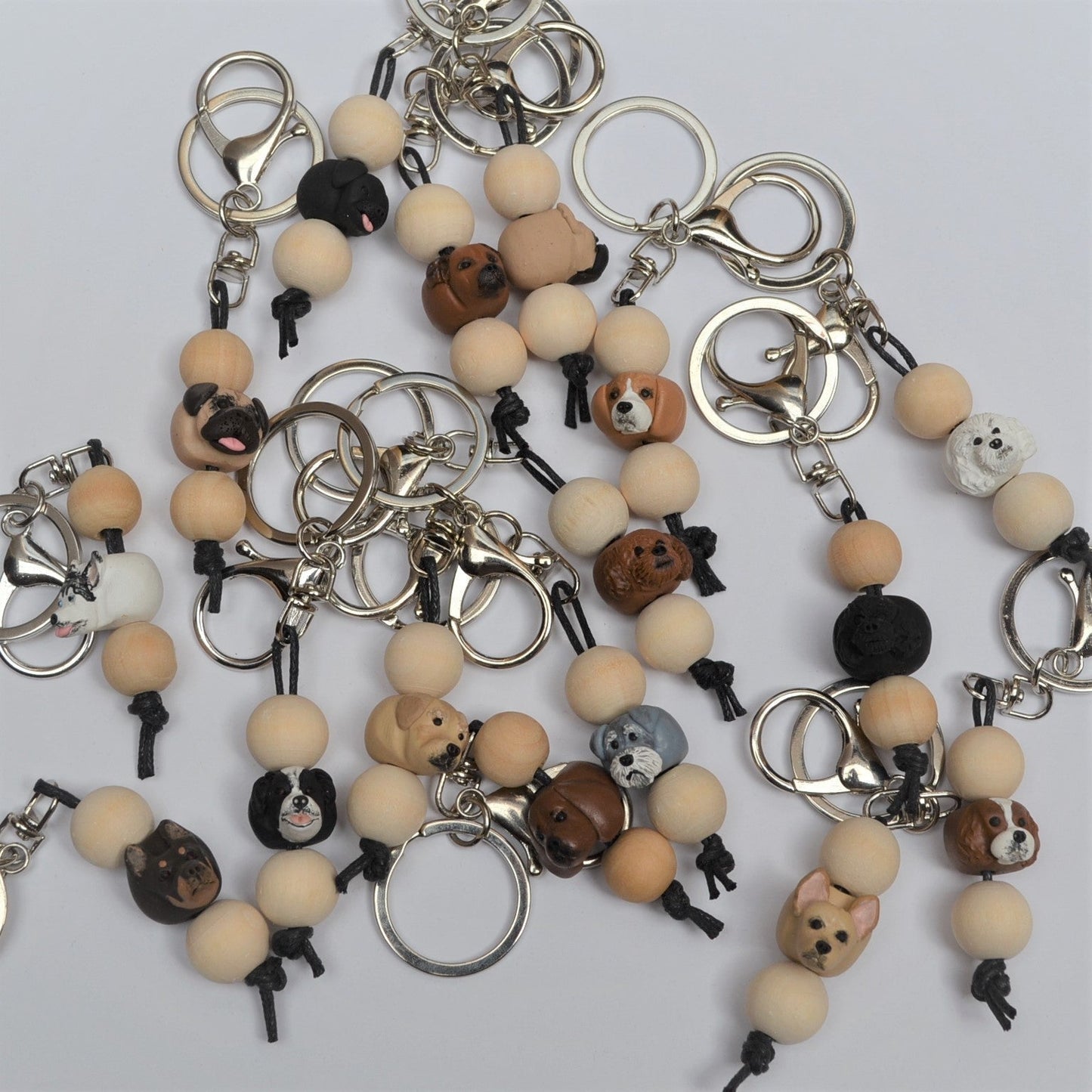 Group shot of timber and polymer clay dog breed keychains on white background