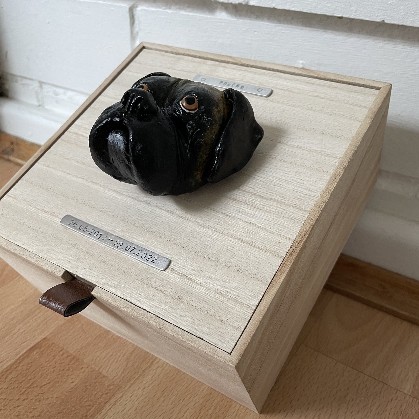 Custom timber pet memorial keepsake box with handscultped dog face on the lid, with a name plaque reading Poncho.