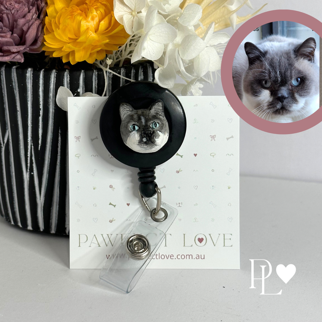 Handmade custom pet face badge reel showing a grey cat's face.