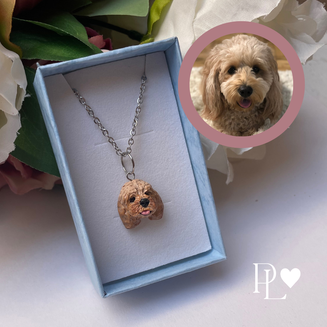 Handmade custom cavoodle dog necklace pendant on chain, in blue display box.