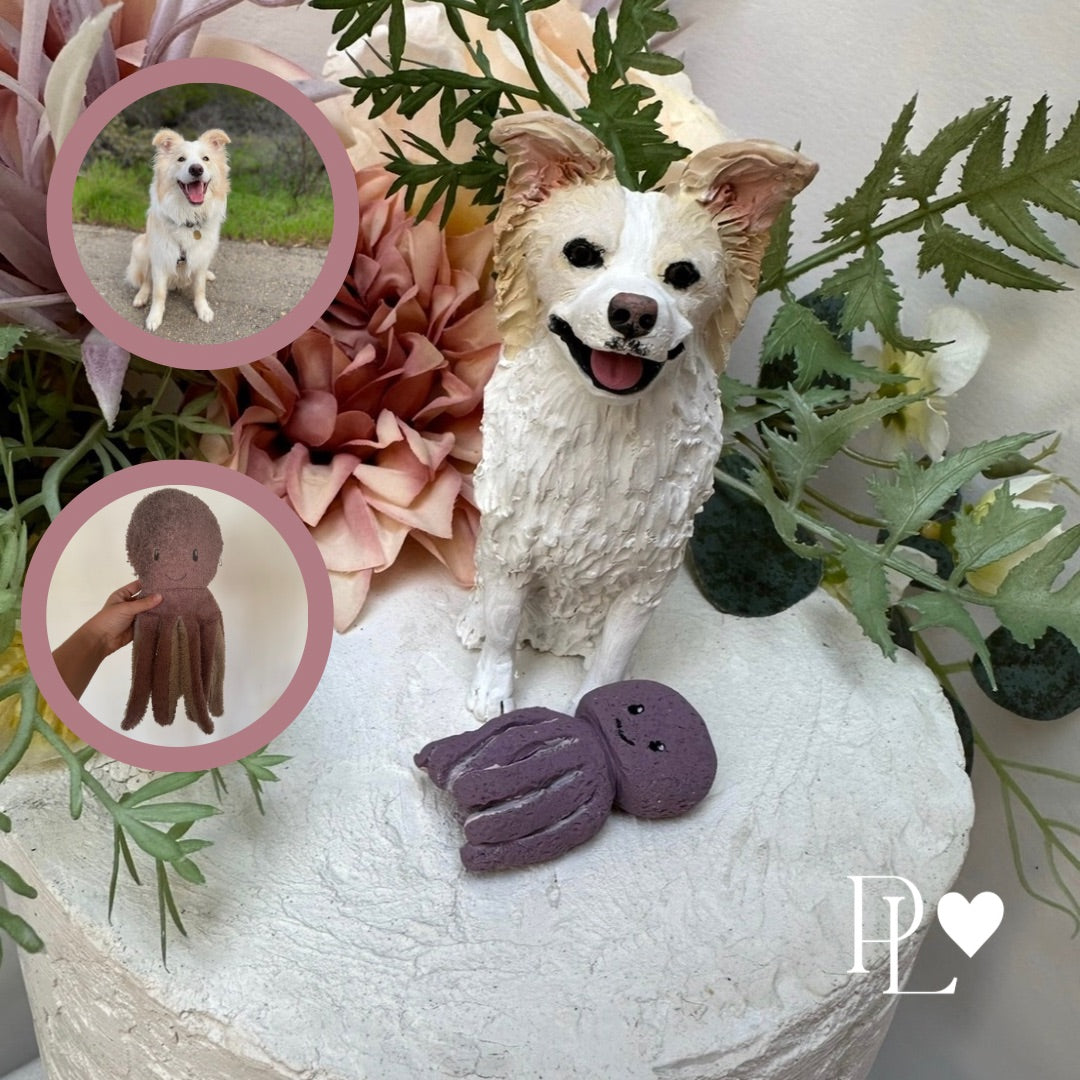 Dog figurine with flowers and a small octopus toy on a white surface