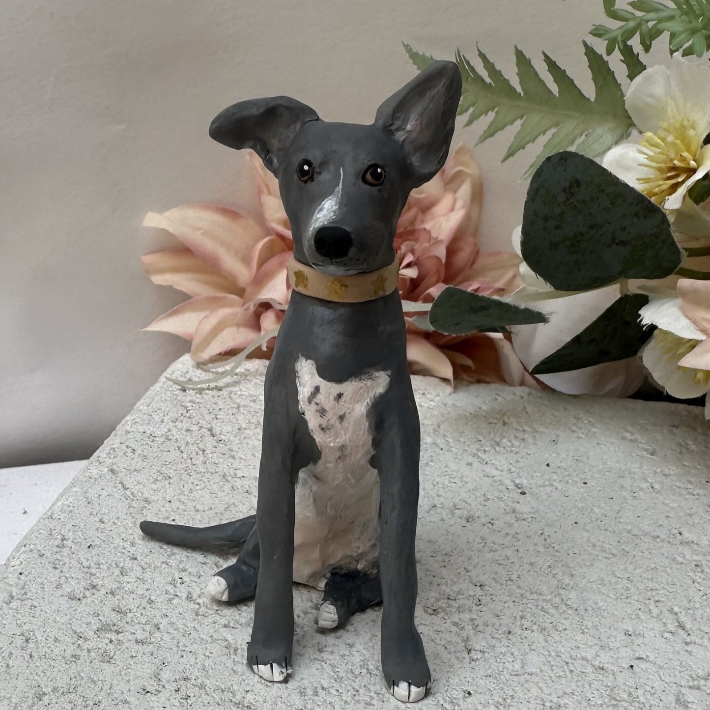 Dog figurine with a floral background