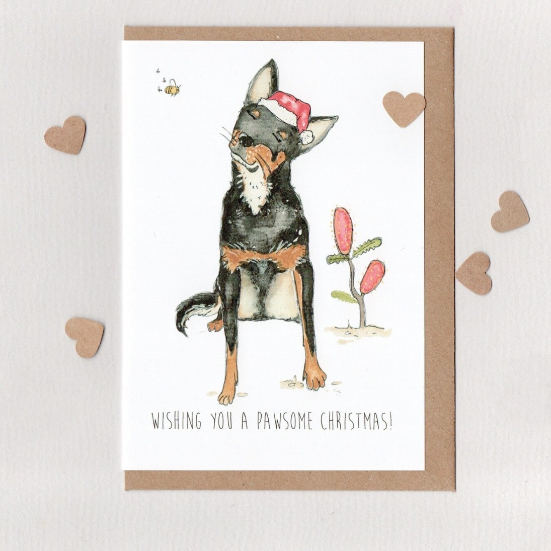 Christmas card with a dog illustration and text 'Wishing you a pawsome Christmas!' on a white background.