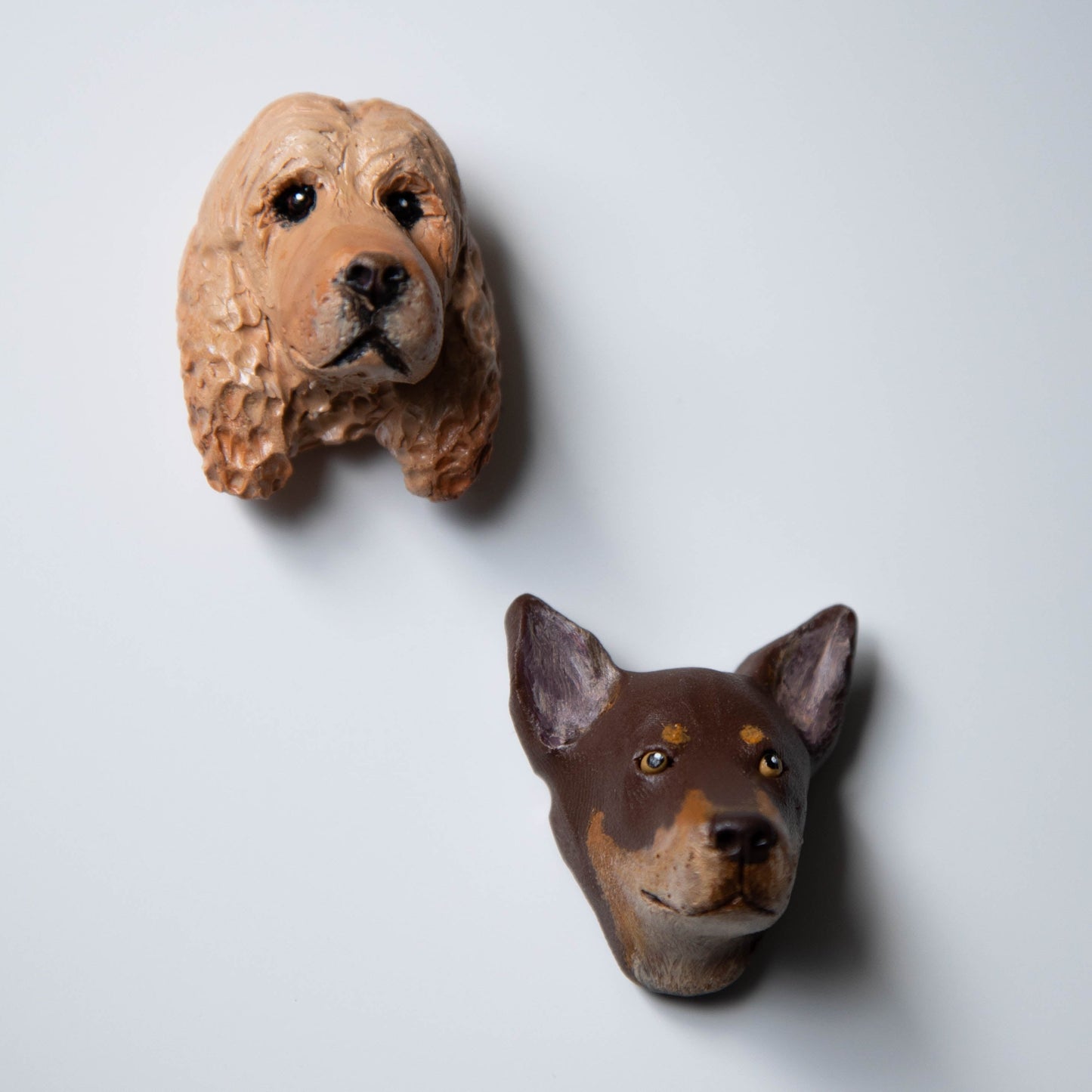 Two dog fridge magnets on a white background