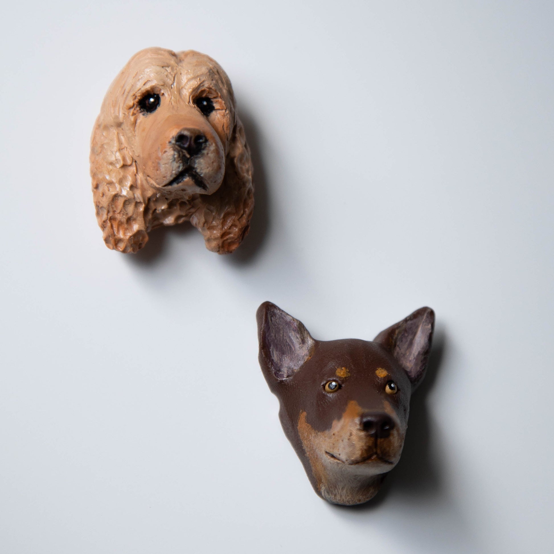 Two dog fridge magnets on a white background