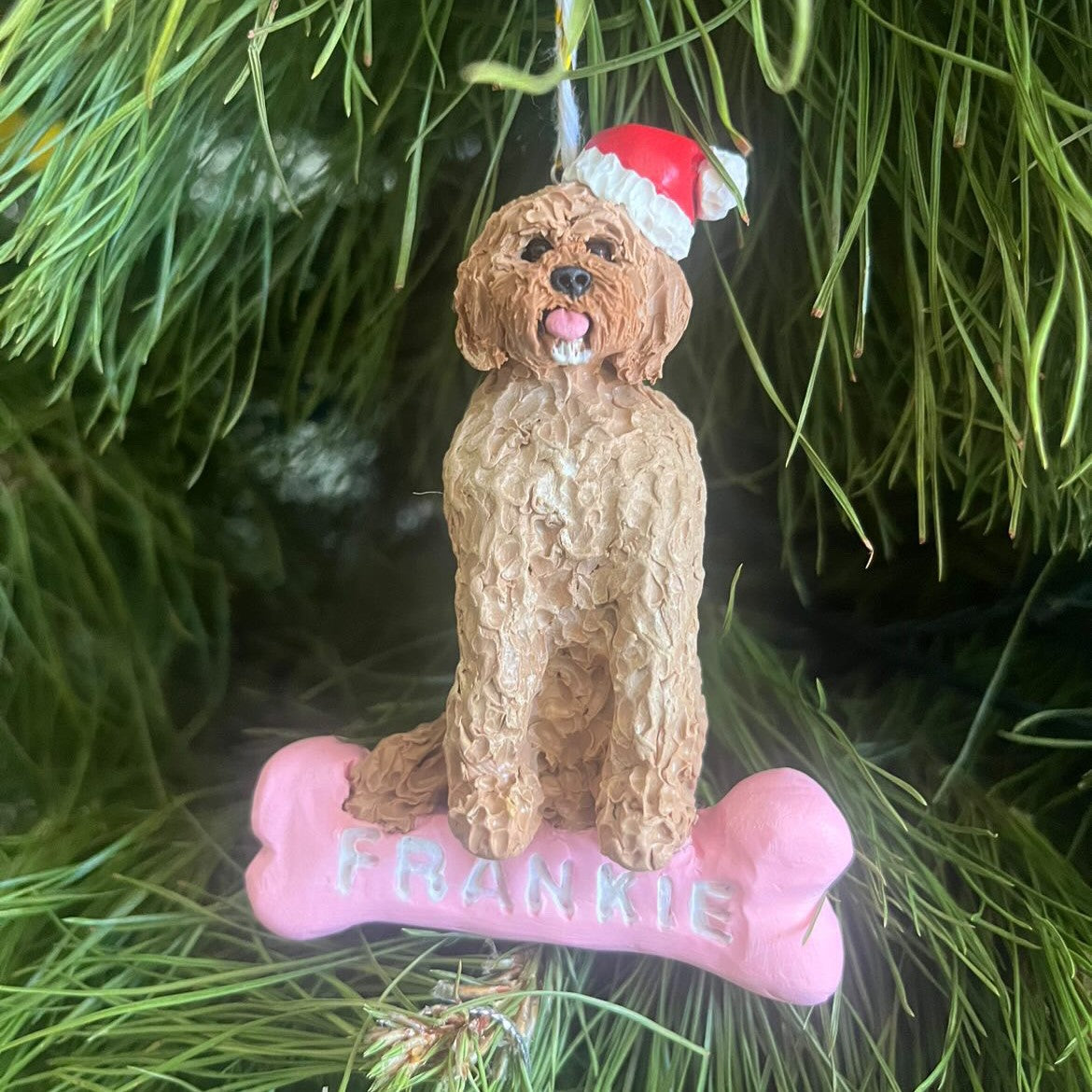 Custom dog sitting on a bone Christmas handing ornament