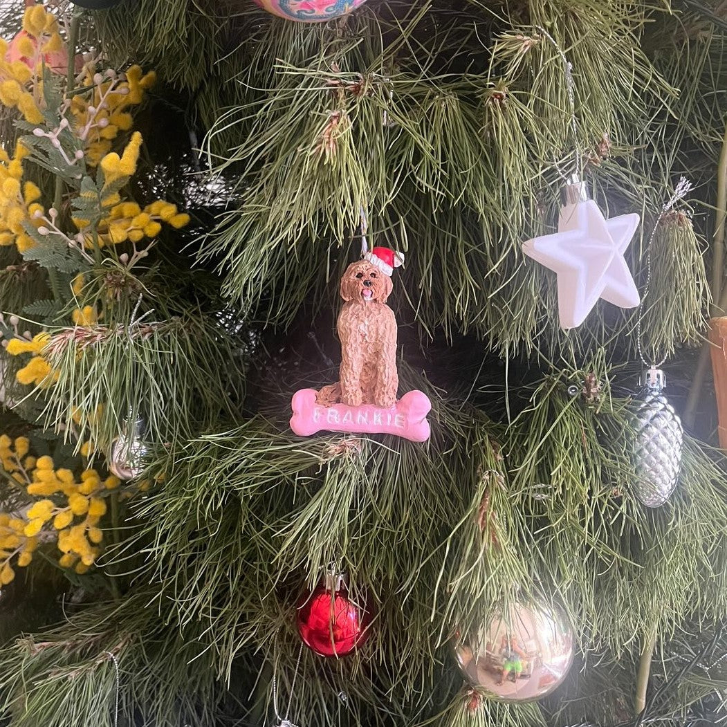 Custom dog sitting on a bone Christmas handing ornament