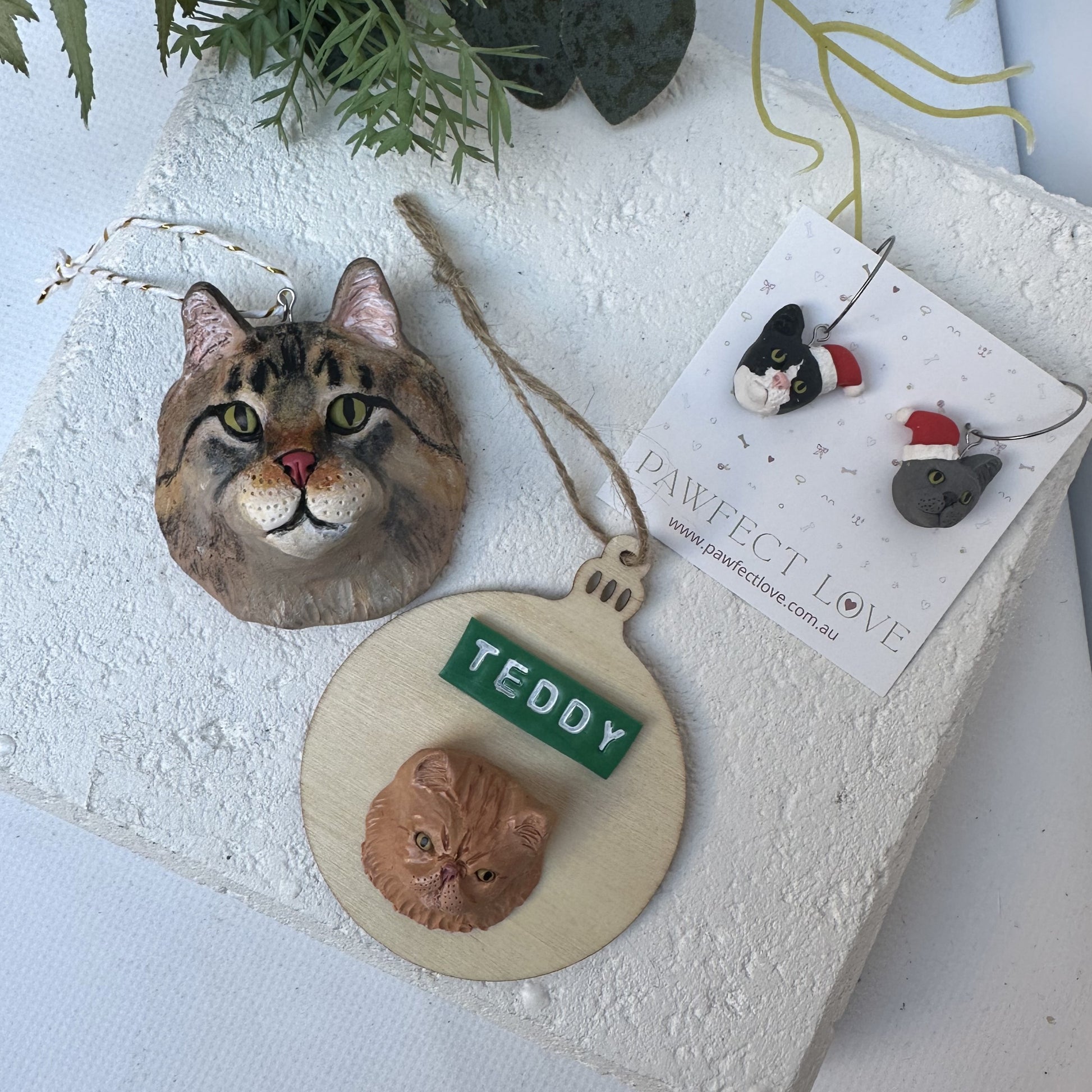 Group photo of cat face Christmas ornaments and earrings