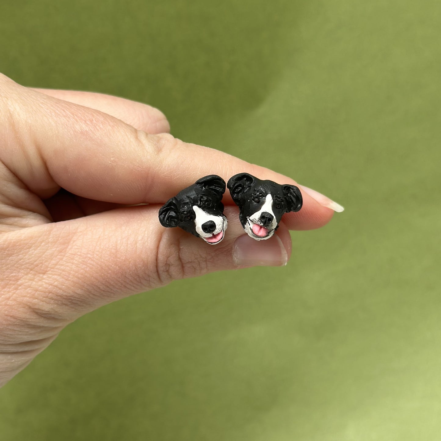 Handmade border collie stud earrings by Pawfect Love, positioned in front of green background