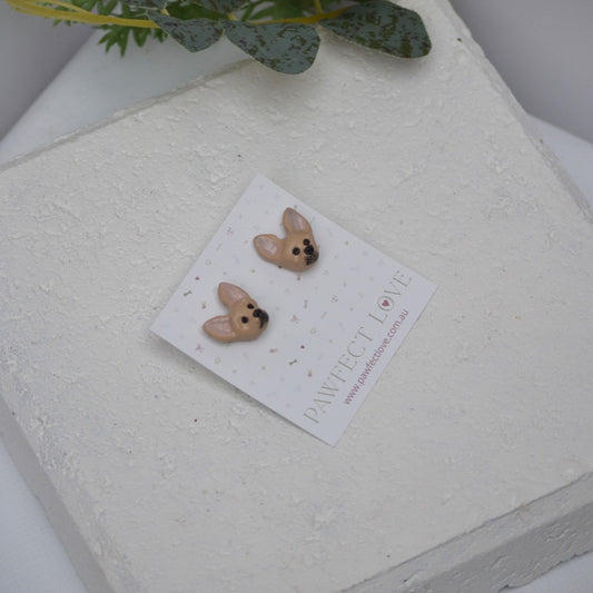 Handmade chihuahua stud earrings by Pawfect Love, positioned on white paver