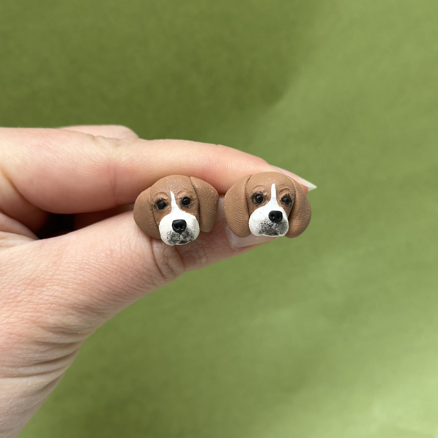 Handmade beagle stud earrings by Pawfect Love, positioned in front of green background