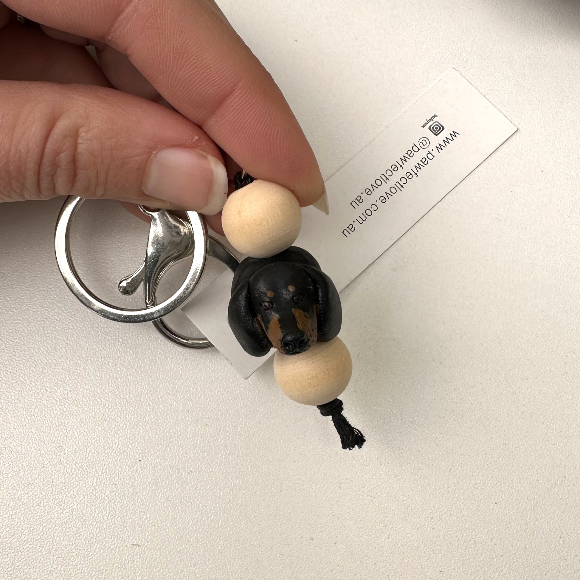 Keychain with a small dachshund dog handmade keyring on a white background
