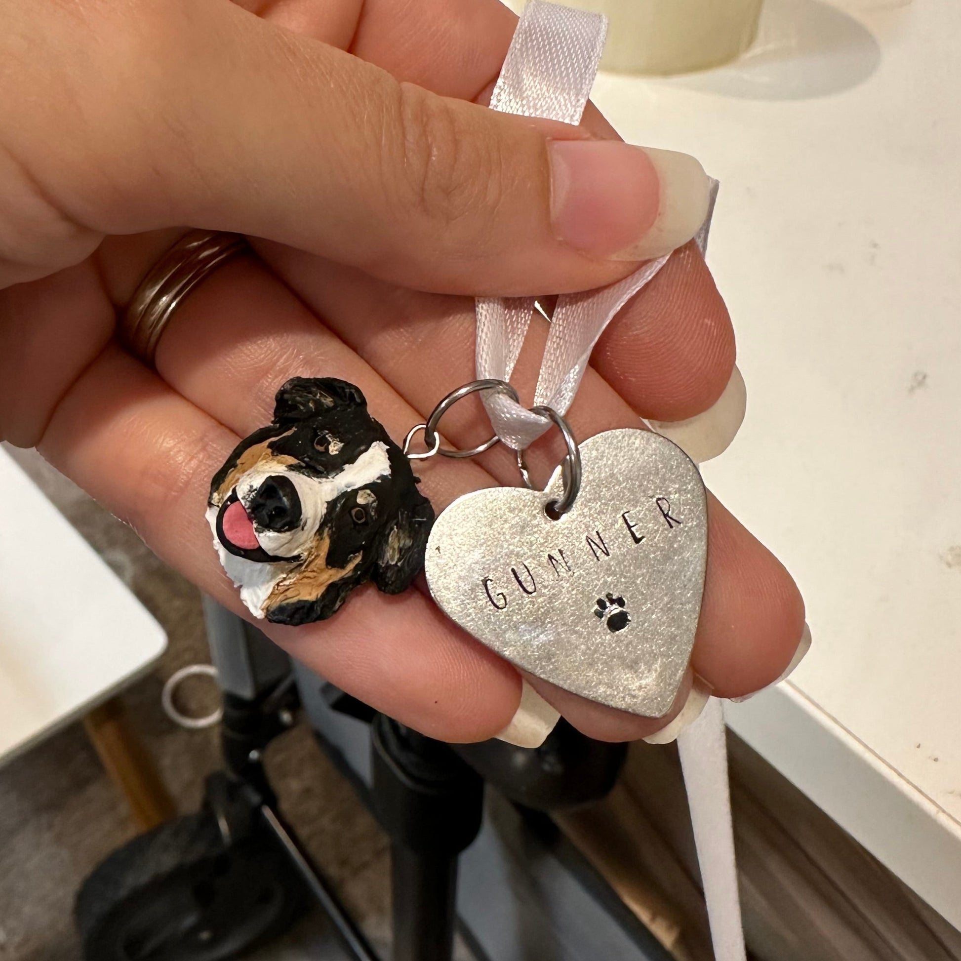 Custom dog urn charm with a heart-shaped tag reading Gunner.