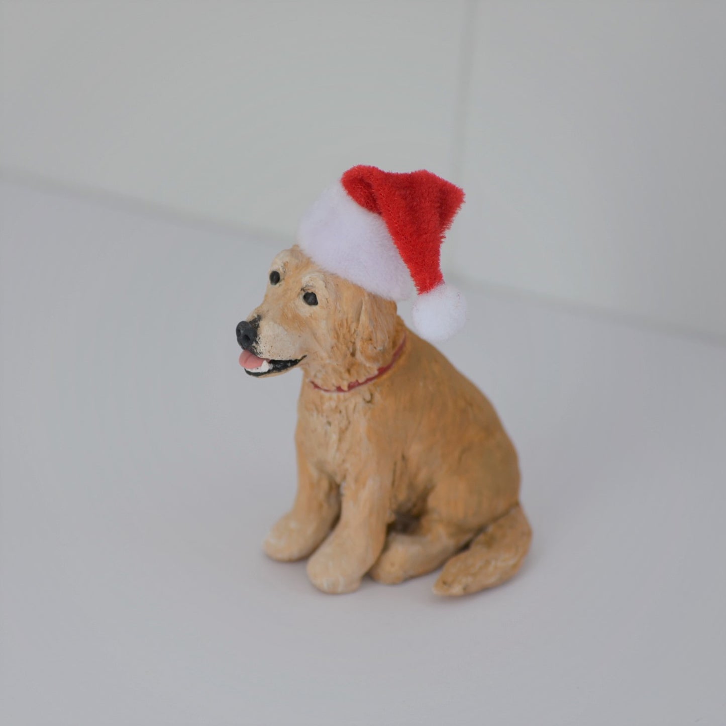 Handmade custom golden retriever dog figurine with santa hat